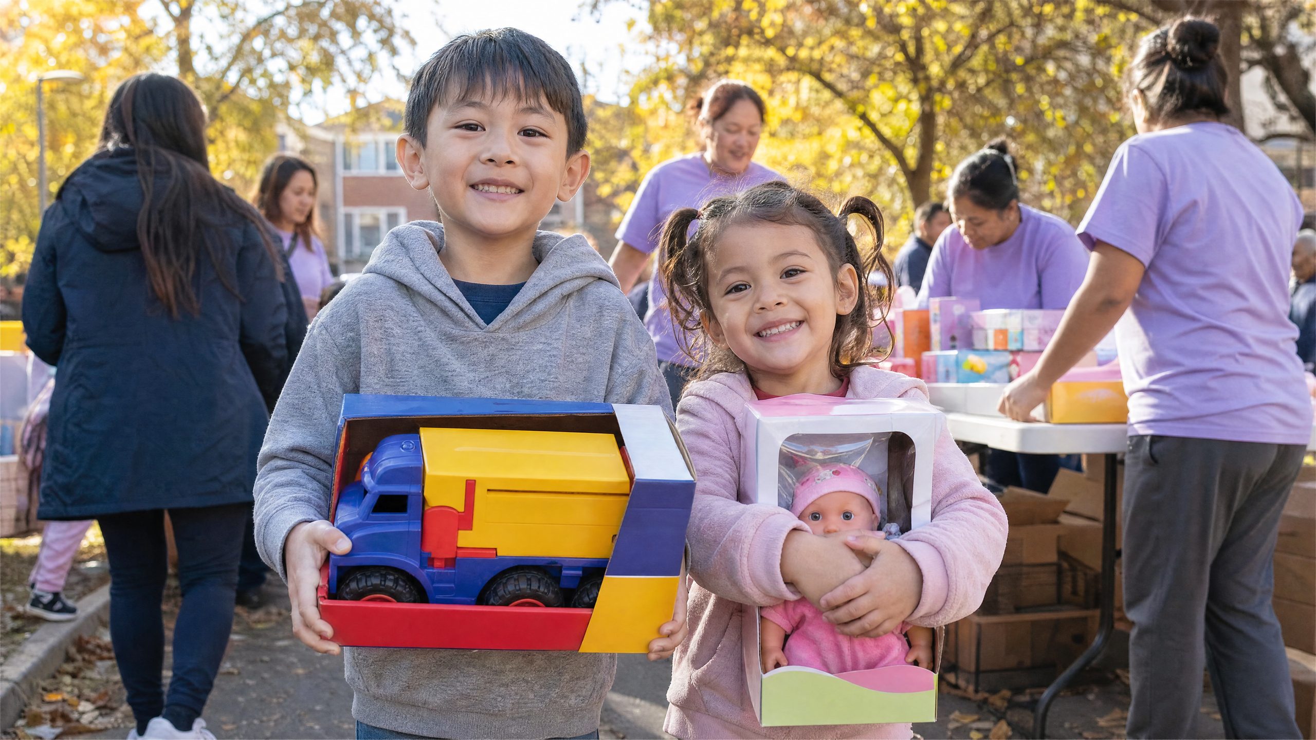 Two smiling children holding their new toys